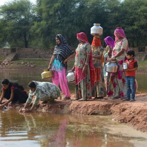 Women-in-Rajasthan-filling-water-from-a-pond-deepened-by-Ambuja-Cement-Foundation.jpg