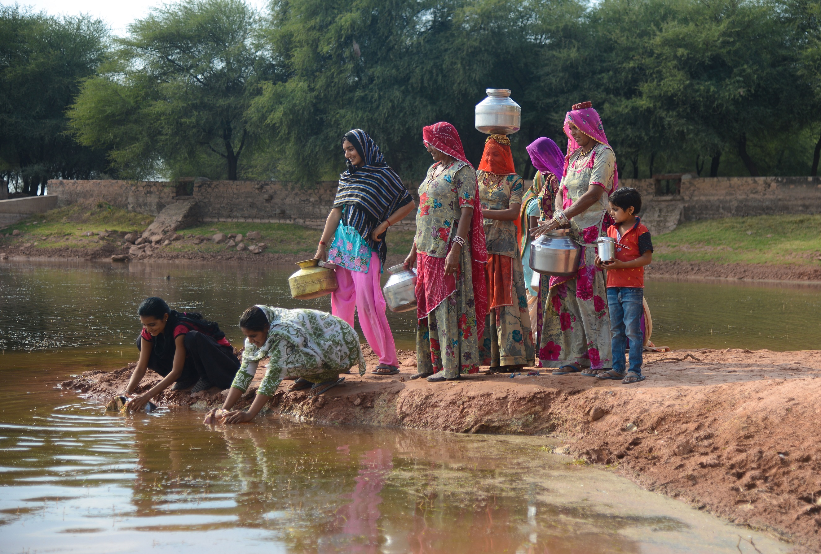 Women-in-Rajasthan-filling-water-from-a-pond-deepened-by-Ambuja-Cement-Foundation.jpg