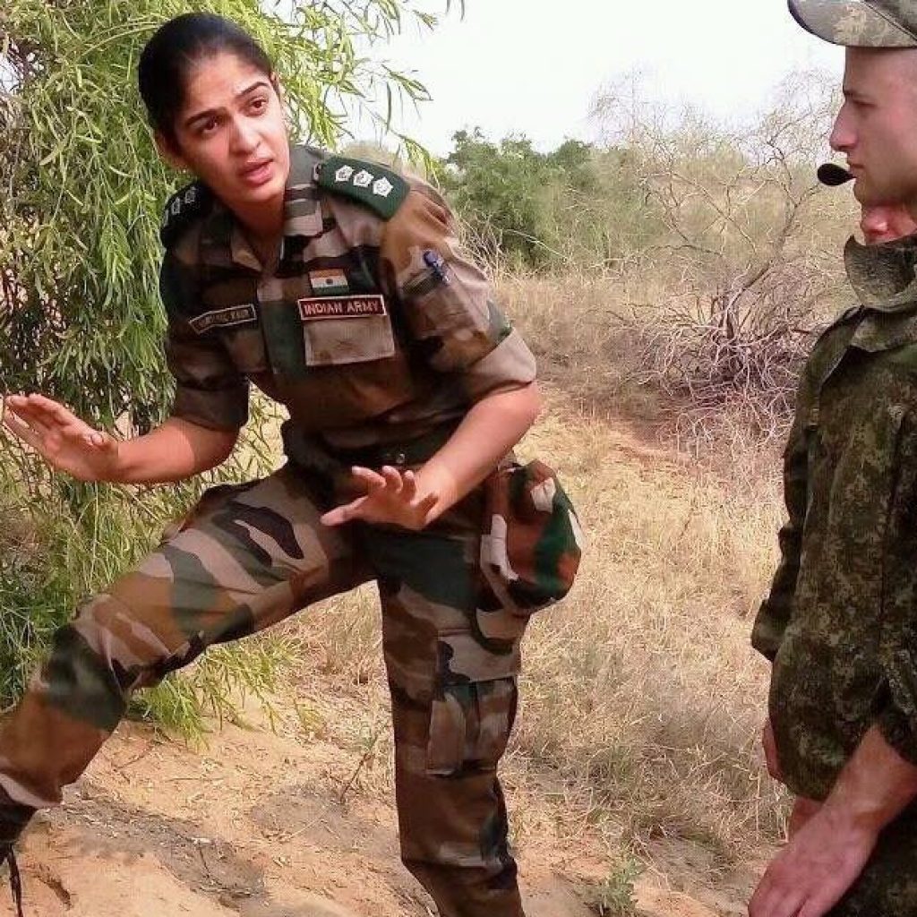 Indian Army woman officer giving demonstration about handling ammunition to foreign troops.