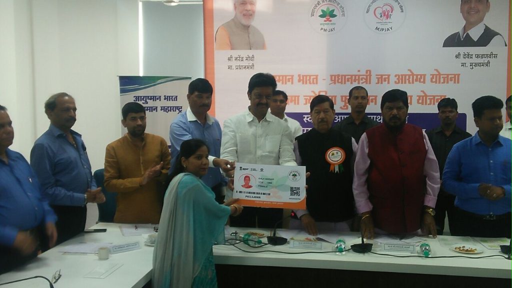 MP Anil Shirole (centre) giving out Family Health e-card to one of the beneficiaries