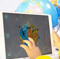 A boy checks out an online geography class provided by Zuoyebang during a recent high-tech exhibition in Wuzhen, Zhejiang province. [Photo by Chen Zebing/China Daily]