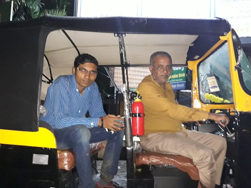 Rahul Shitole sitting in autorickshaw of his father Rajendra Shitole, who inspired him to launch the autorickshaw app.