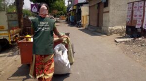 A SWaCH worker going collect waste from doors of people.