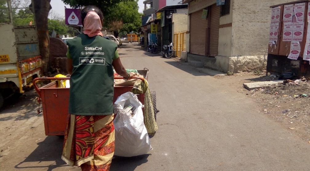 A SWaCH worker going collect waste from doors of people.