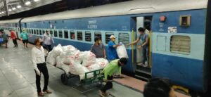Volunteers haul snack packets and give for everyone in coaches