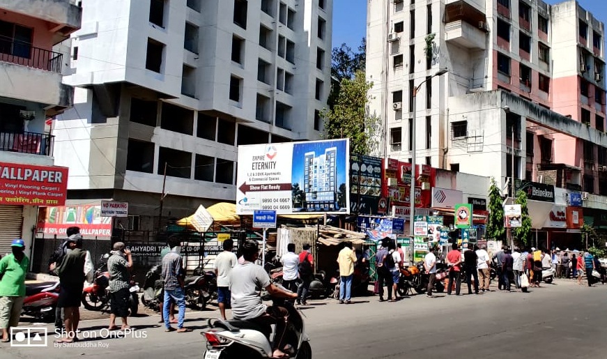 People crowd outside a wine shop in Salunke Vihar Pune.