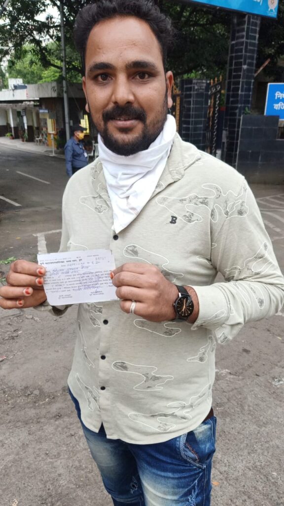 A man shows fine receipt for not wearing mask.