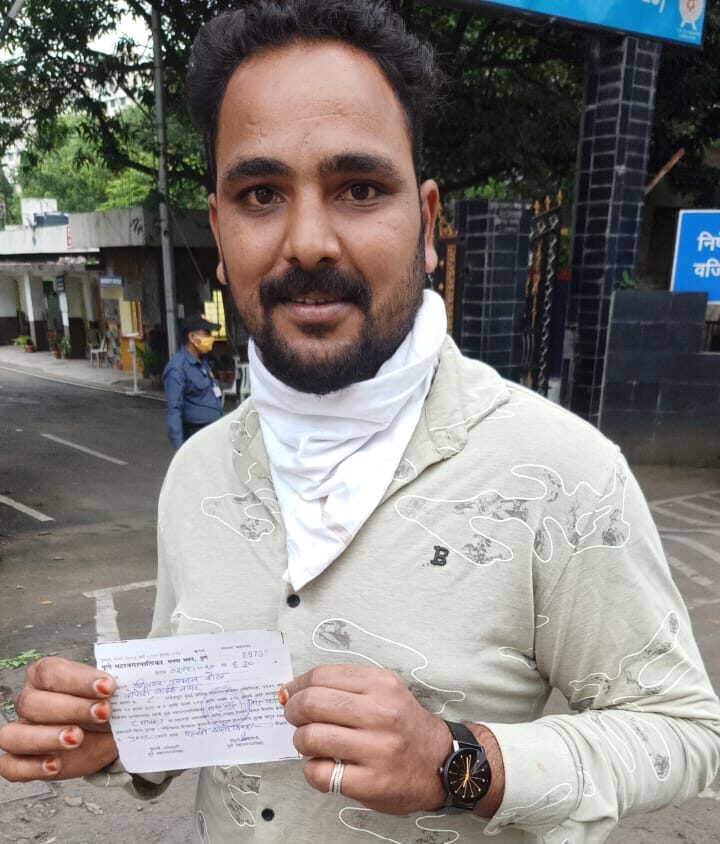 A man shows fine receipt for not wearing mask.