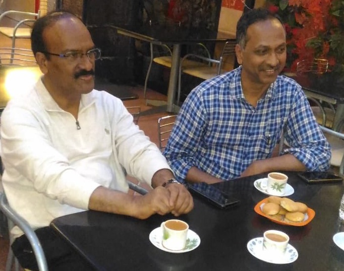 Dr Venkatesham and his friend Dr Janardhan Reddy (then Hyderabad Municipal Commissioner) discussing best practices for Public Service over chai-biscuit at a hotel in Hyderabad in August 2018.