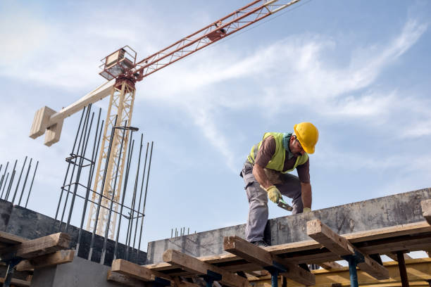 Worker At Construction Site Is Fixing The Form For The Beam