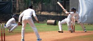 Harsh Khandve of Varroc playing attacking shot against Vision Cricket Academy bowler at Vision Sports Ground