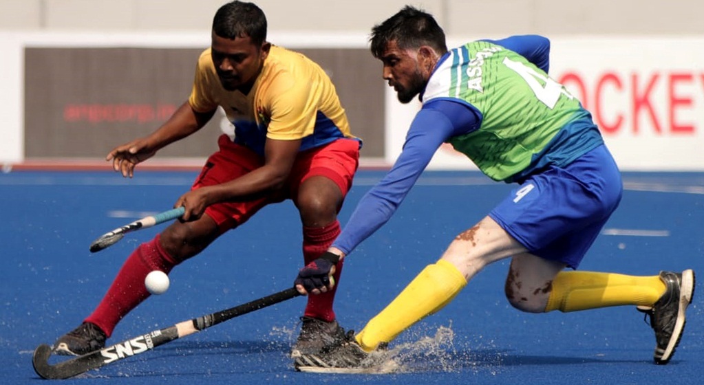 Players of Hockey Jharkhand (Yellow) and Assam Hockey (Green) in action