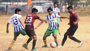 Action photo of match between Dynamites FC(Maroon) and Laukik FC(White).