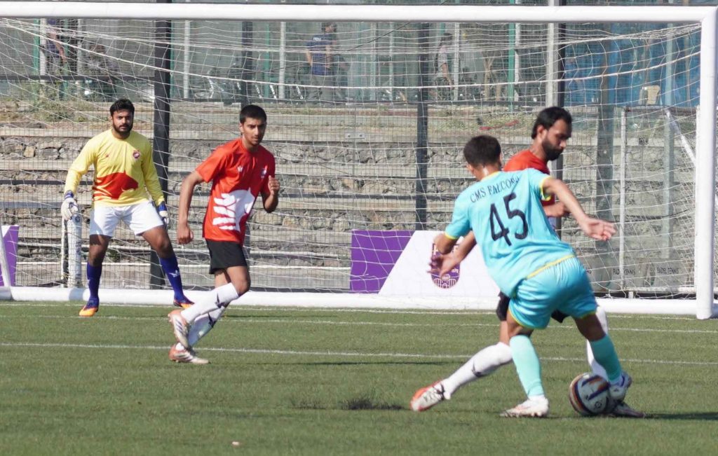 Action photo of match between Chetak FC(Orange Shirt) and CMS Falcons(Sky Blue Shirt)