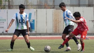 Action photo of match between Diego Junior FC(White & Sky Blue Shirt) and Thundercatz FC(Orange Shirt)