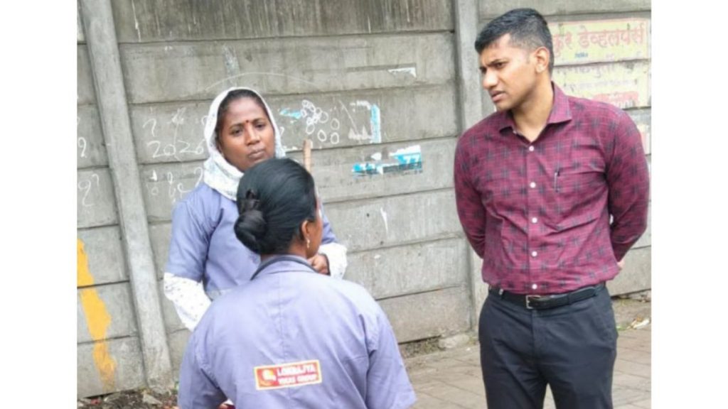 PMC Additional Commissioner Prajit Nair interacts with sanitation workers during an inspection.