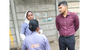 PMC Additional Commissioner Prajit Nair interacts with sanitation workers during an inspection.
